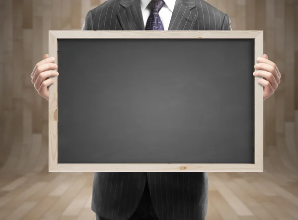 Affärsman anläggning blackboard — Stockfoto