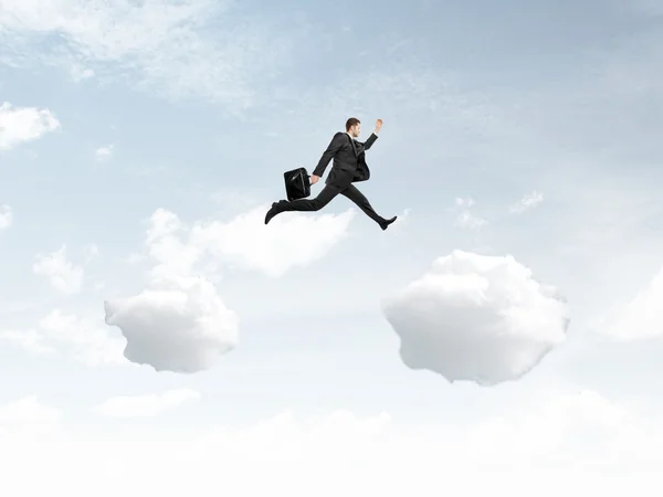 Man jumping from cloud — Stock Photo, Image