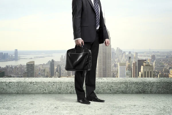 Businessman hanging by a rope — Stock Photo, Image
