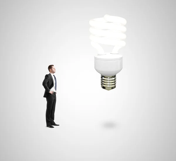 Man looking on energy lamp — Stock Photo, Image