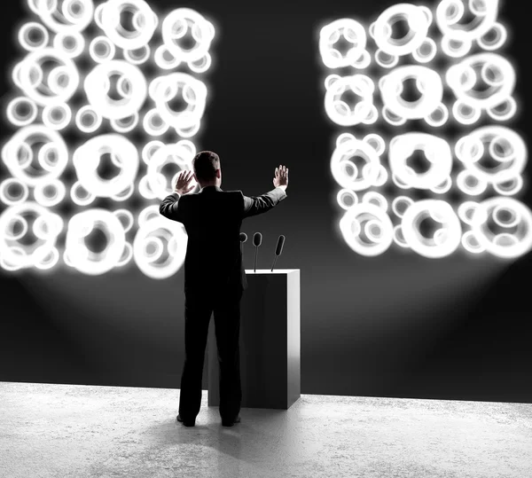 Businessman standing on stage — Stock Photo, Image