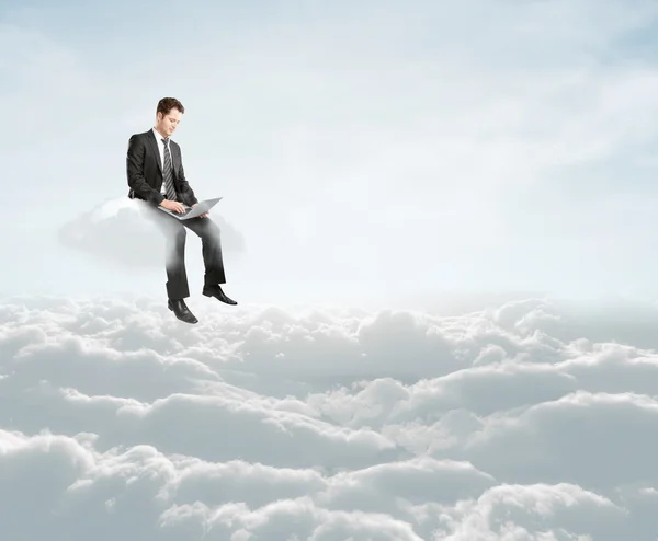 Businessman sitting on cloud — Stock Photo, Image