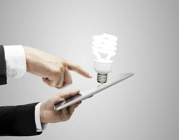 Tablet and lightbulb — Stock Photo, Image