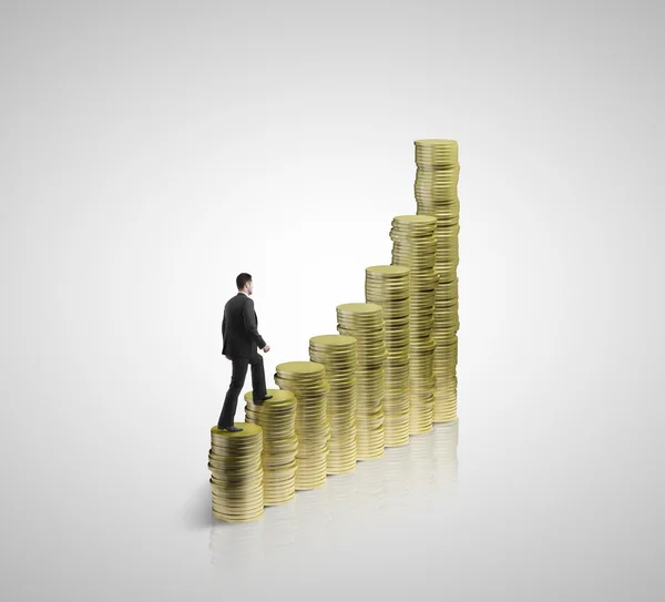 Businessman walking on coins — Stock Photo, Image