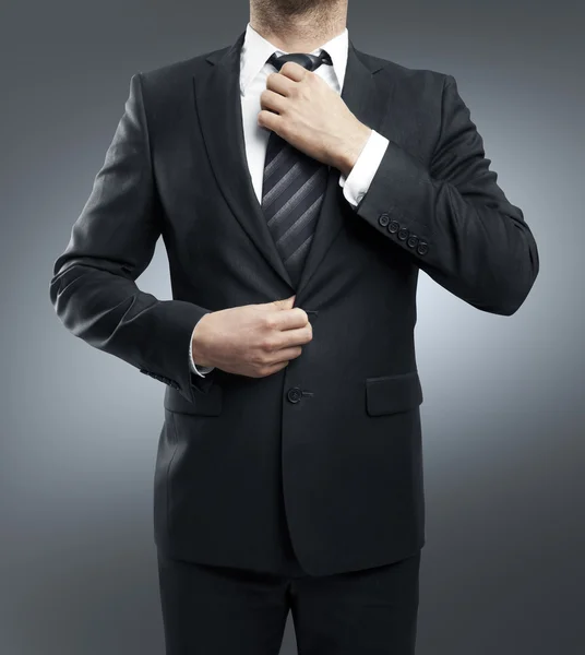 Man adjusts tie — Stock Photo, Image