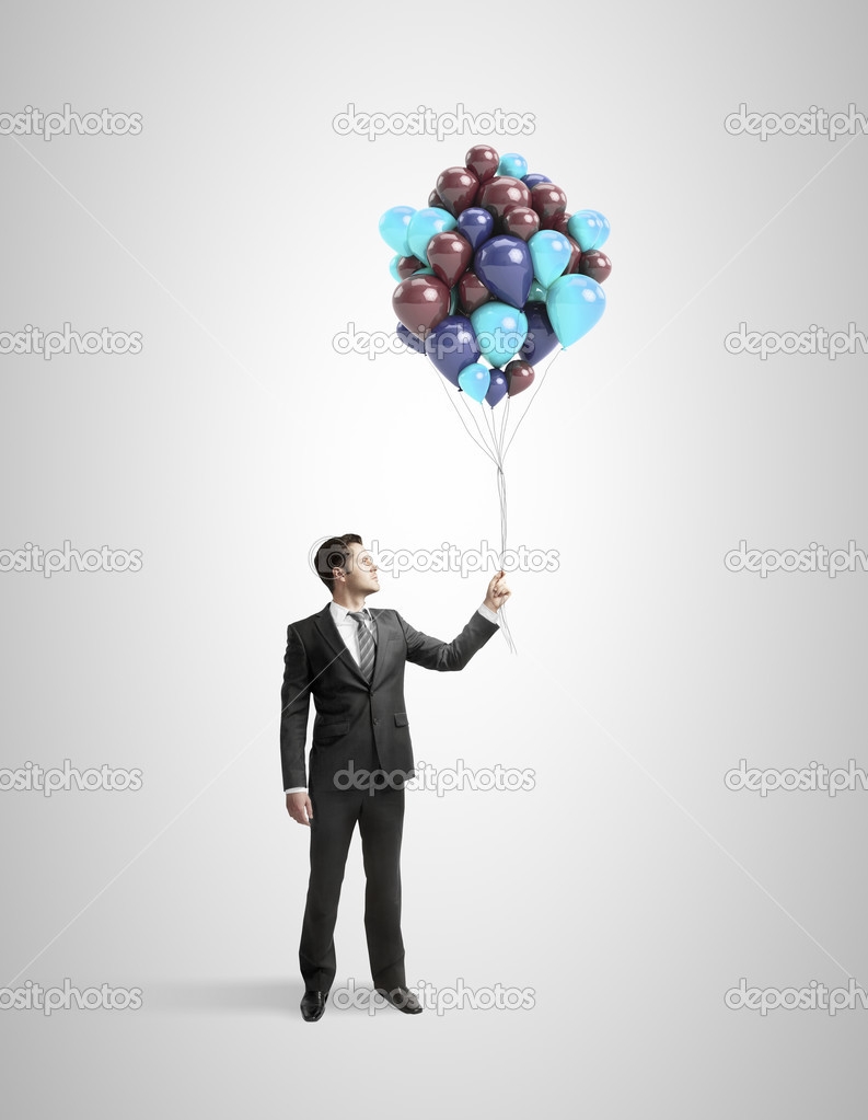 businessman holding baloons