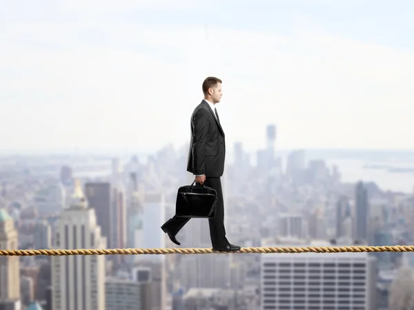 Businessman walking on a rope — Stock Photo, Image