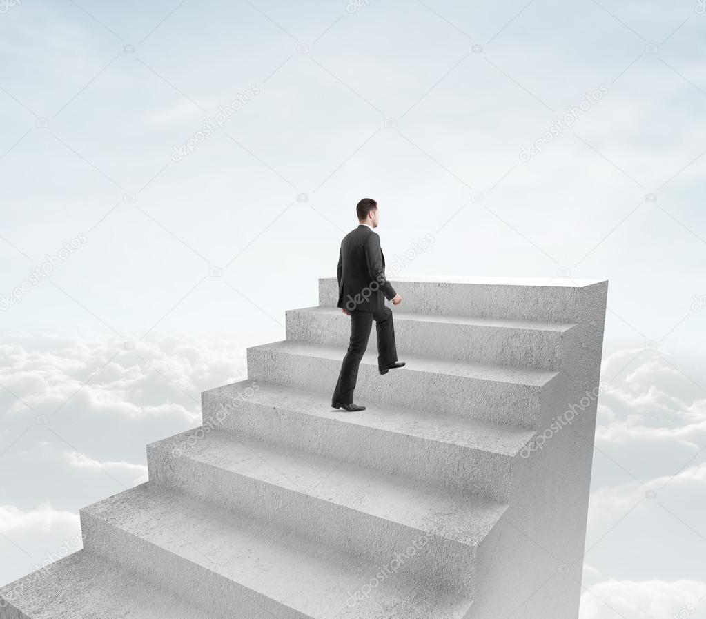 businessman climbing to stairs in cloud