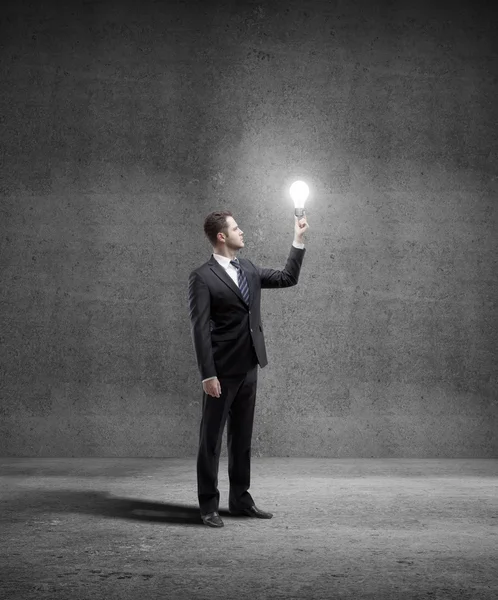 Businessman with lightbulb — Stock Photo, Image