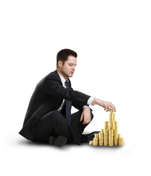 Businessman building coin city — Stock Photo, Image