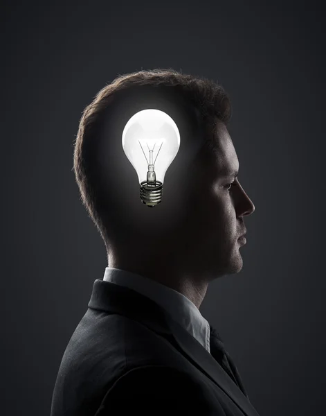 Businessman with lamp — Stock Photo, Image