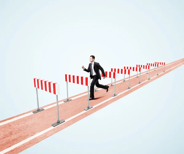 Businessman jumping over barrier — Stock Photo, Image