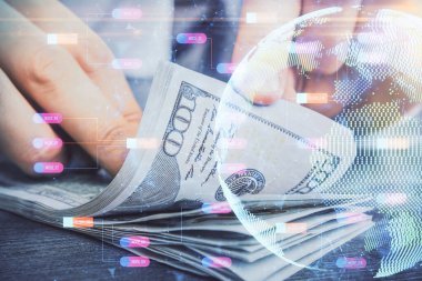 Dünya haritasının iki katına çıkarılması hologram, dolar banknotları ve insan eli..