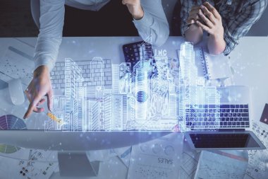 Kadın ve erkeğin birlikte çalıştığı ve binaların hologram çizimlerinin çifte pozlanması. Bilgisayar arkaplanı. Üst Manzara. Akıllı şehir konsepti.