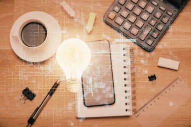 Ampulü telefonla masanın üzerine çizerken çift pozlama. Üst Manzara. Fikir kavramı.