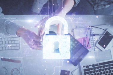 Kadın ve erkeğin birlikte çalışıp hologram çizimlerini kilitlerken çift pozlama. Güvenlik kavramı. Bilgisayar arkaplanı. Üst Görünüm.