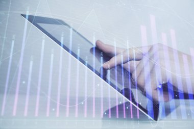 Dijital telefon ve forx grafik çizimi kullanarak adamın elini tutarken birden fazla pozlama. Finansal piyasa kavramı.