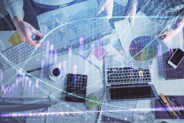 Birlikte çalışan kadın ve erkeğin çifte pozu ve finansal grafik hologramı çizimi. Pazar analizi konsepti. Bilgisayar arkaplanı. Üst Görünüm.