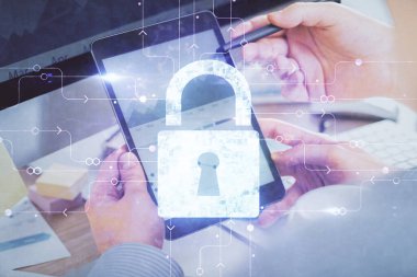 Dijital bir cihaz ve kilit çizimi kullanan bir adamın el ele tutuşması. Güvenlik kavramı.