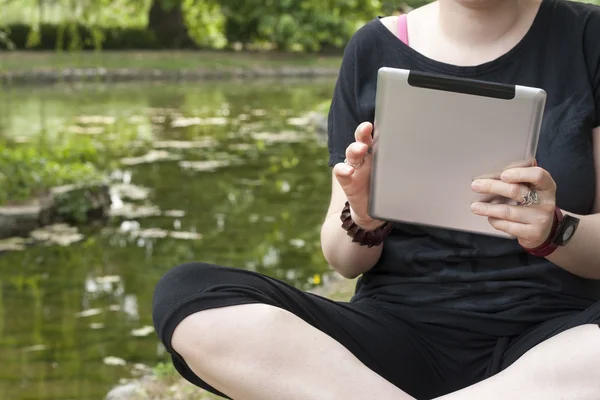 Mulher e tablet computador no parque — Fotografia de Stock