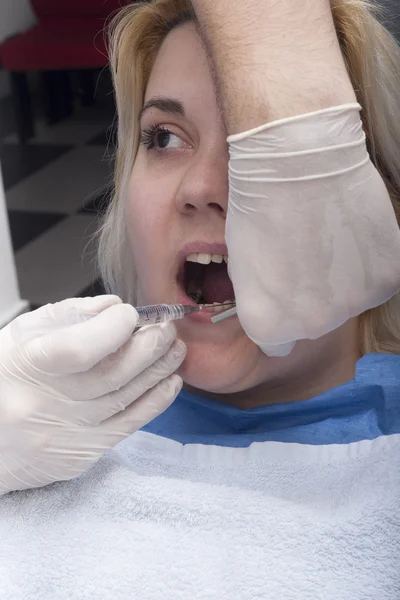 Стоматолог анестезирует пациента — стоковое фото