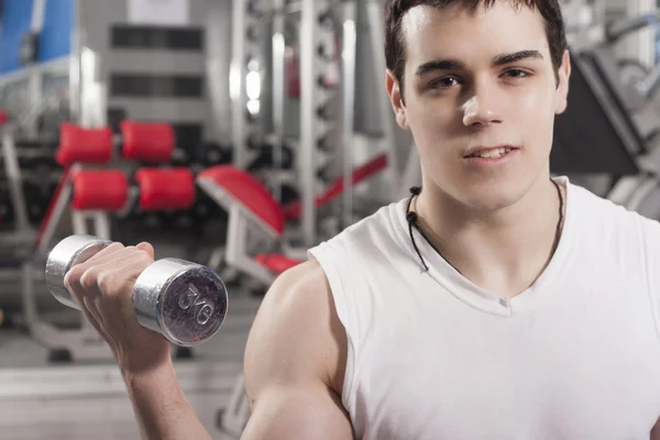 Strong handsome man exercising at the gym — Stock Photo, Image