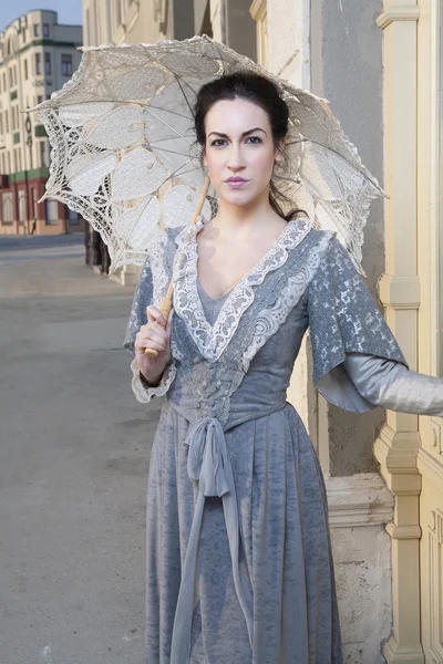 Woman with umbrella on street — Stock Photo, Image