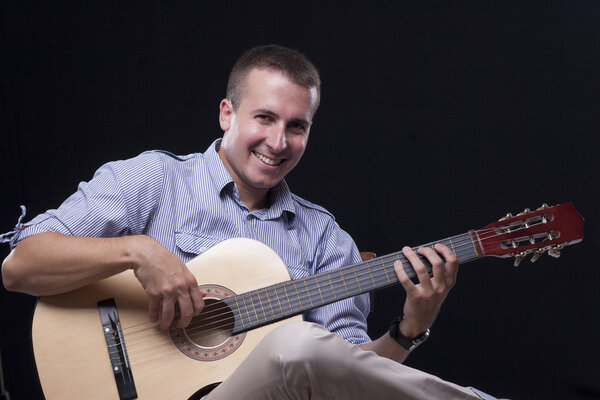 Young man playing acoustic guitar