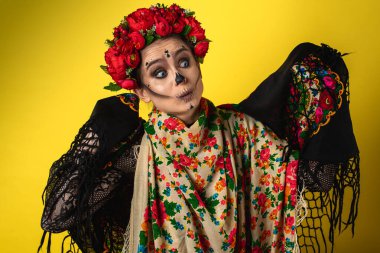 Kalavera Katrina 'nın görüntüsündeki kız vücudunun çeşitli duygusal hareketlerini gösteriyor, yüz, başörtüsü, sarı arka plan, görünüş ve kenar, yazıtlar için bir yer. Dia-de -los -muertos. Ölüm günü. Cadılar Bayramı.