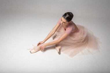 Arka planda oturan yorgun balerin.