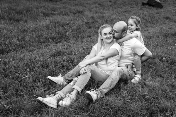 黒と白の写真 幸せな家族は夏の公園で草の上に休んでいる 家族の概念 — ストック写真