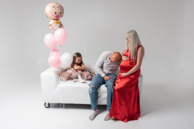 Hafif bir geçmişi olan güzel hamile bir kadın, neşeli, kutlayan ve şaşırtan. Aile ve bebek doğumu kavramı.