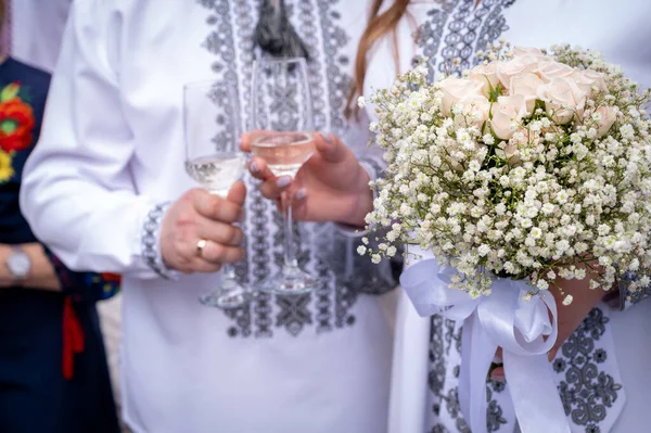 wedding rings on the hands of the young, the creation of a new young family, in Ukrainian embroidered shirts