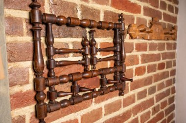 wooden vintage Ukrainian hanger hangs on a brick wall 