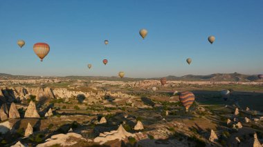 Hot-air ballons flying above Cappadocia at dawn. Turkey, May 2021