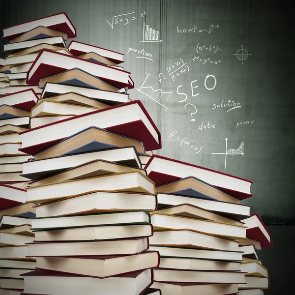 Books stacked with formulas fund, education — Stock Photo, Image