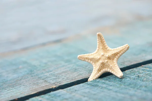 Starfish on blue wooden — Stock Photo, Image