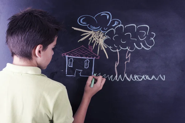 Boy with chalkboard — Stock Photo, Image