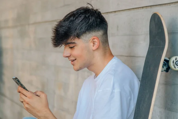 Tonåring Med Mobiltelefon Och Skateboard Gatan — Stockfoto