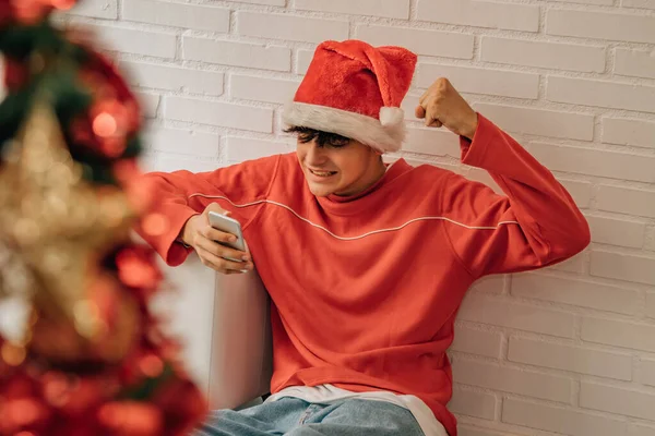 Teenager Wearing Santa Claus Hat Christmas Home Looking Mobile Phone — Stock Photo, Image