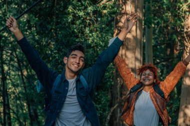 Sırt çantalı mutlu bir çift gezintiye çıkar ya da yürüyüş talimi yapar.