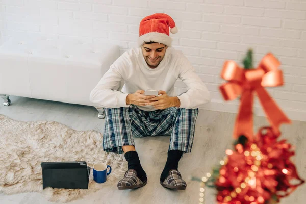 Homme Avec Santa Claus Chapeau Maison Avec Téléphone Portable Ordinateur — Photo