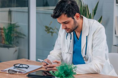 Danışmanlık ya da iş yerinde cep telefonu olan doktor