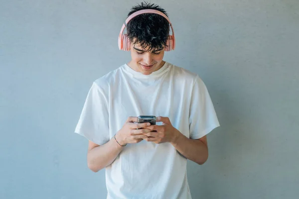 Teen Boy Mobile Phone Headphones Listening Music Isolated Wall Copy — Stock Photo, Image