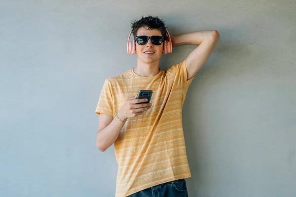 young man with headphones and mobile phone