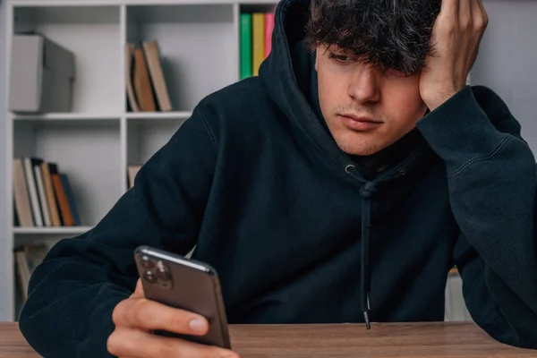 Bored Teen Boy Looking Mobile Phone — Stockfoto