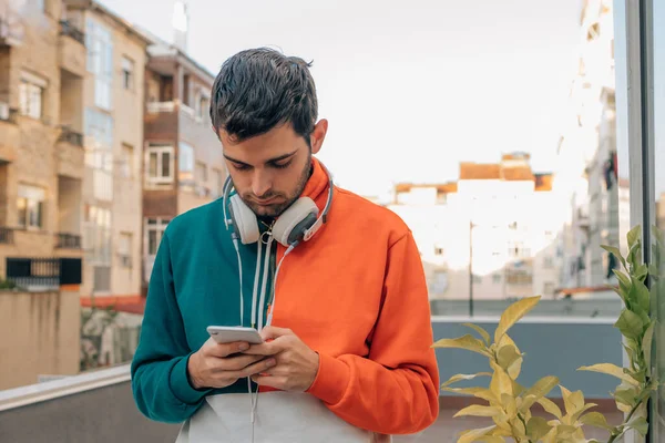 young man on the street looking at the mobile phone