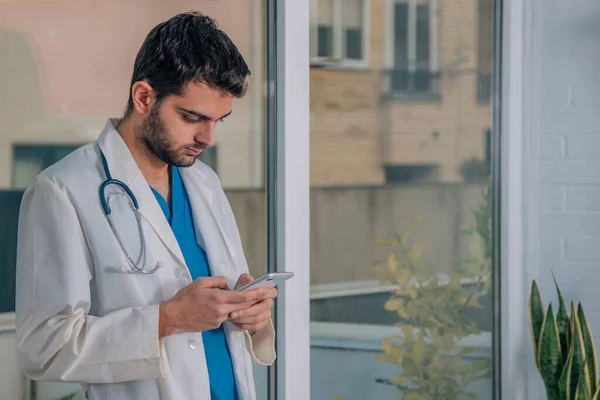 doctor with mobile phone in hands