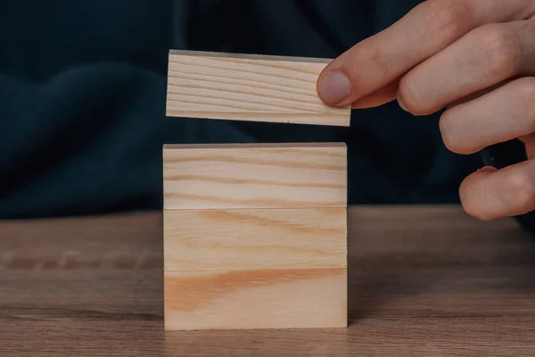 Hand Placing Stacked Construction Part — 스톡 사진