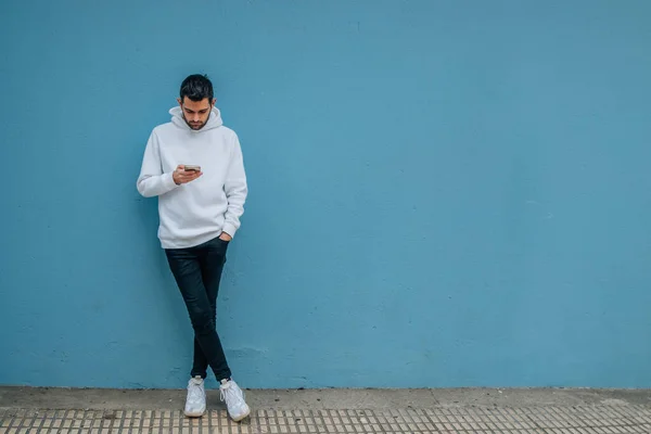Fashionable Young Man Mobile Phone Blue Street Wall — Stockfoto